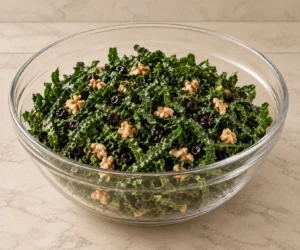 Thin kale, cooled currants and prepared walnuts lightly dressed before Pecorino