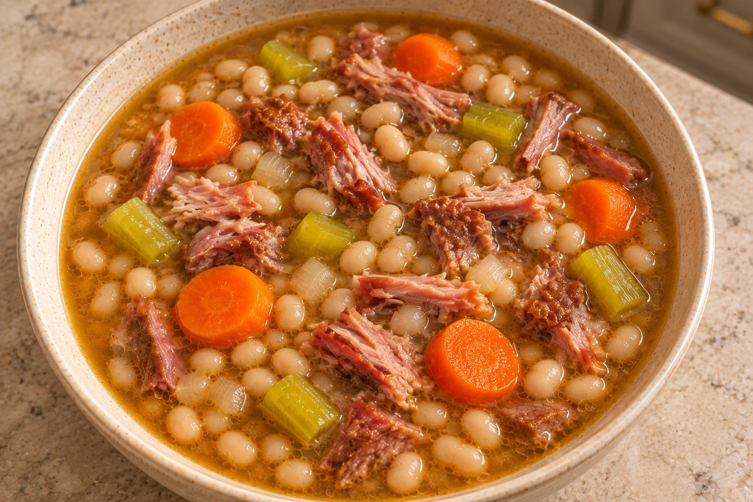High-angle view of white navy bean and pork hock soup