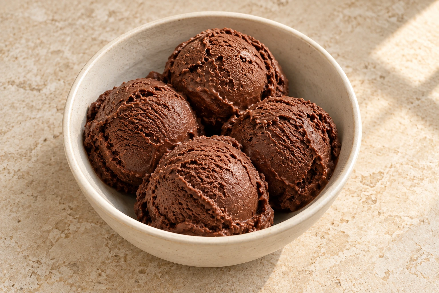 Close overhead bowl of dark chocolate ice cream with natural churned texture