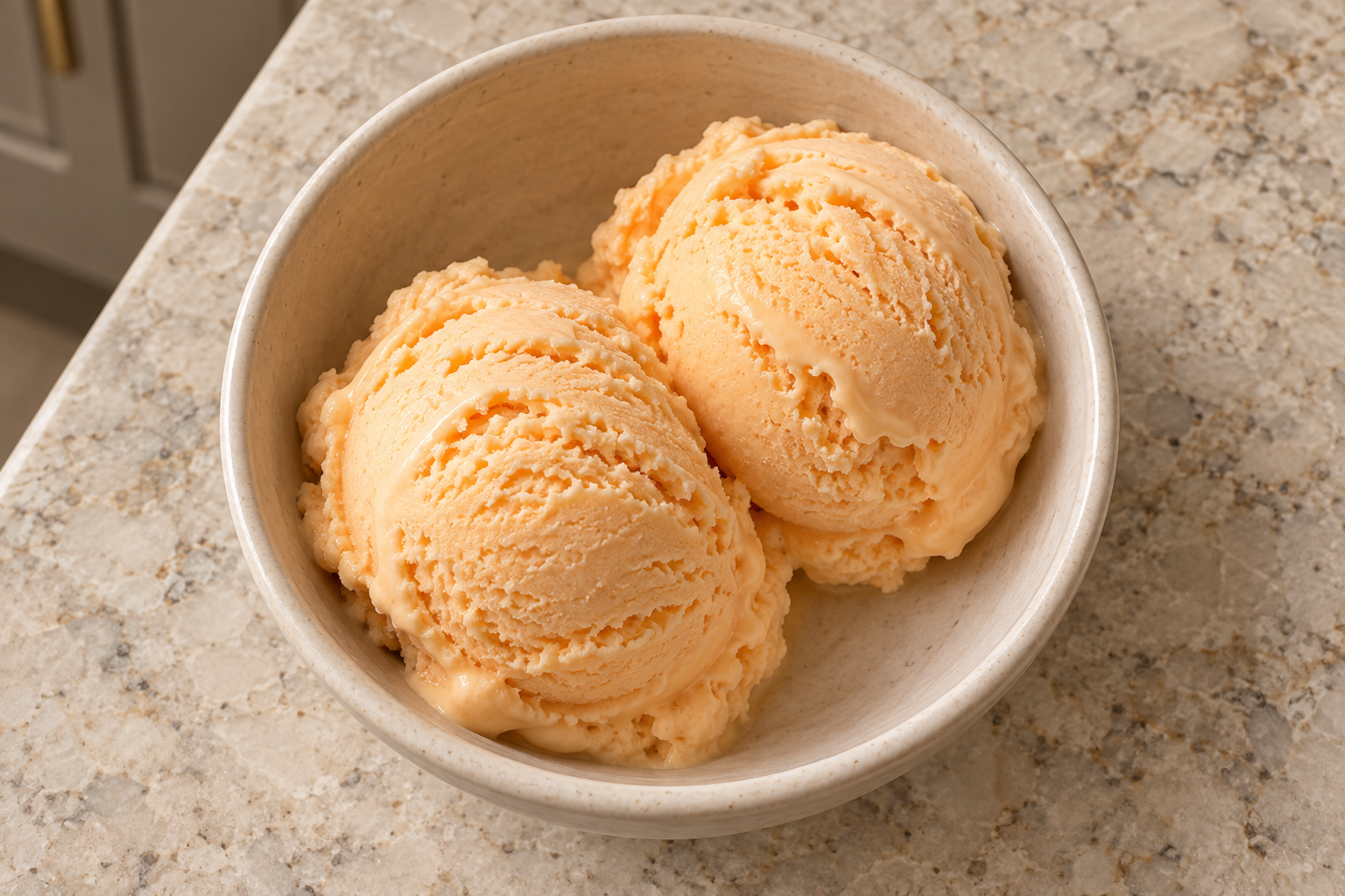 Overhead view of two scoops of cantaloupe sour cream ice cream
